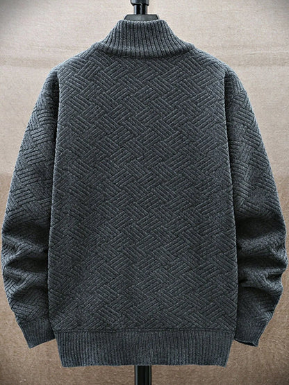 Gray textured sweater on a mannequin against a beige background