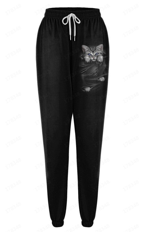 Black jogger pants with a cat graphic on a white background