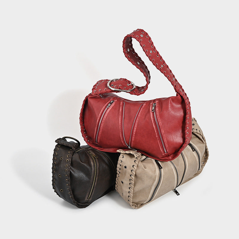 Three shoulder bags with zipper details on a white background.