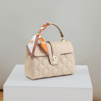 Beige handbag with a matching scarf on a light gray background