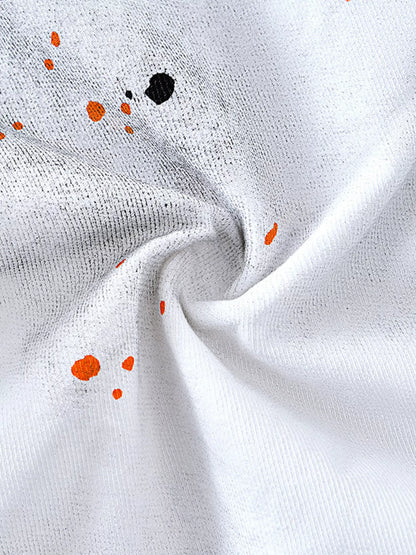 Close-up of white fabric with orange and black specks