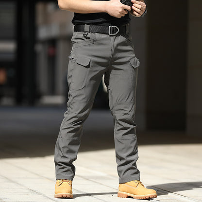 Person wearing gray cargo pants with a blurred background