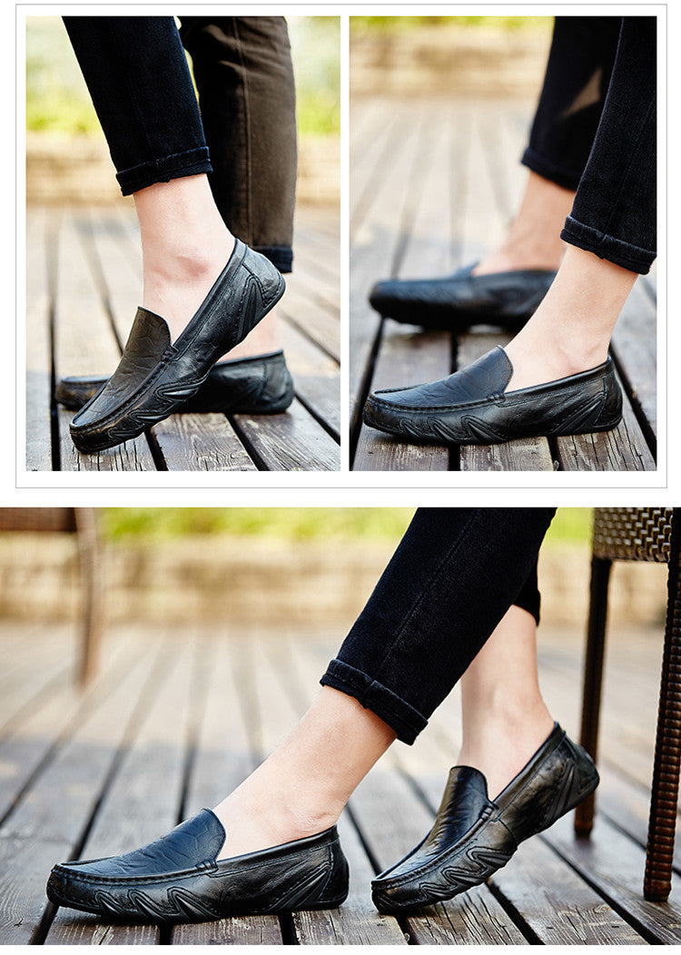 Black loafers worn on a wooden floor with blurred background
