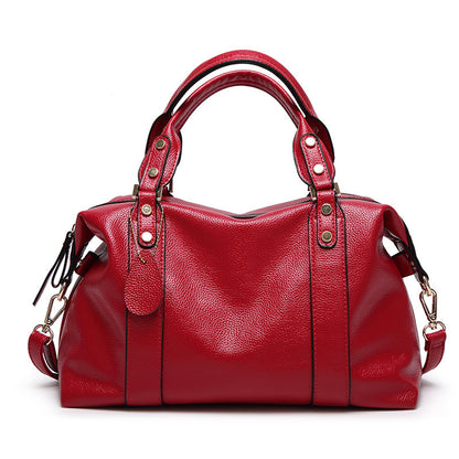 Red handbag with gold accents on a white background