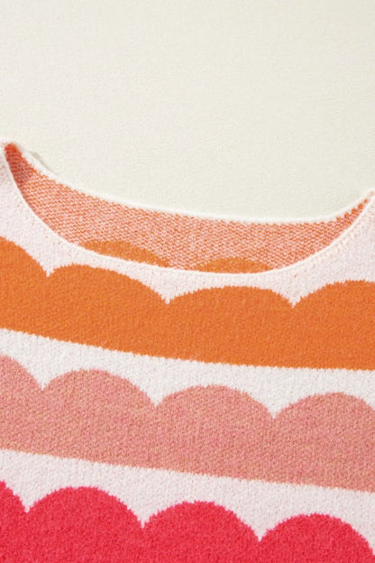 Close-up of a fabric with scalloped pattern in orange, pink, and white.