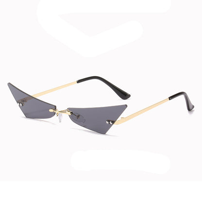 Sunglasses with thin gold frame and black arms on a white background