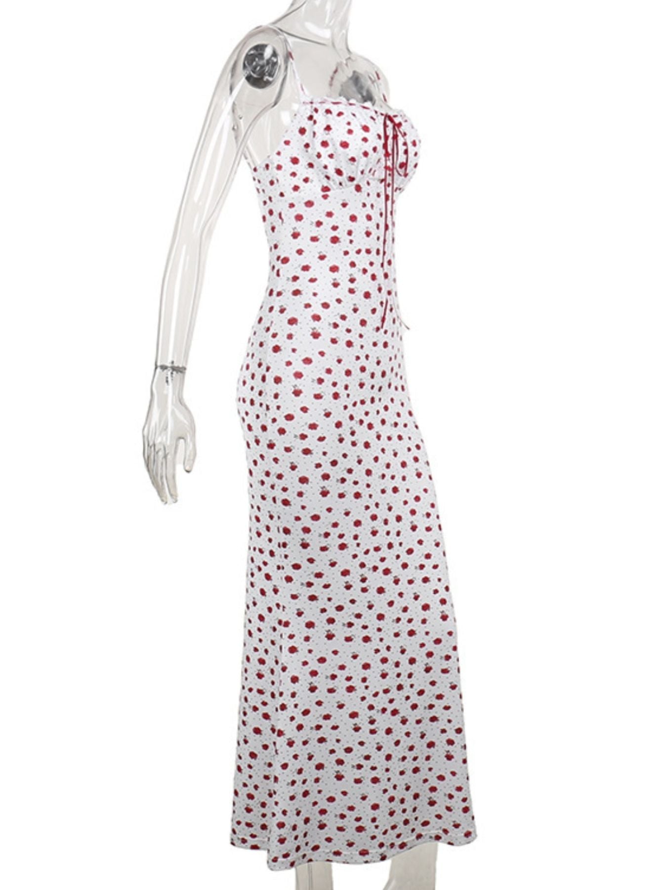 White dress with red polka dots on a mannequin against a white background