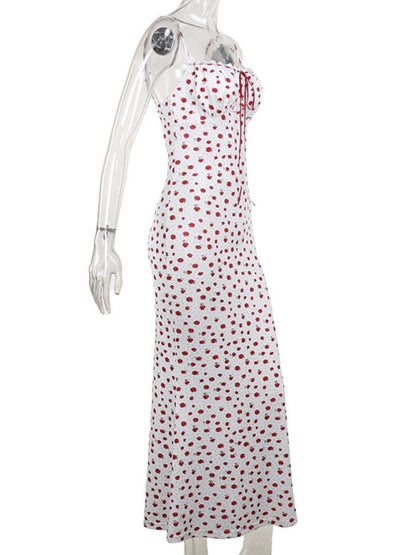 White dress with red polka dots on a mannequin against a white background