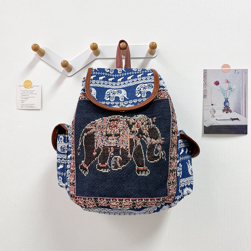 Backpack with elephant design hanging on a wall hook