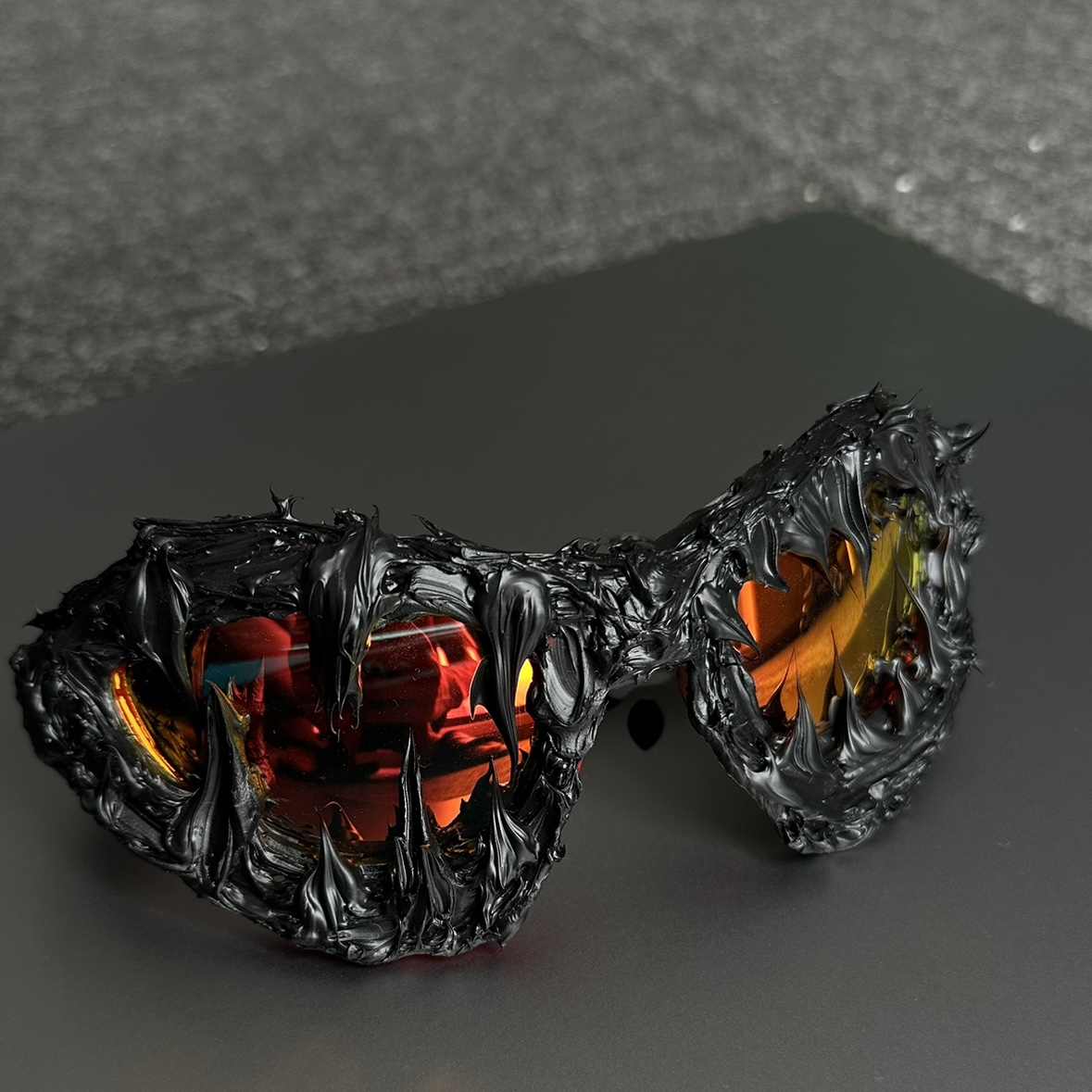 Glowing black and orange sunglasses with a dark background