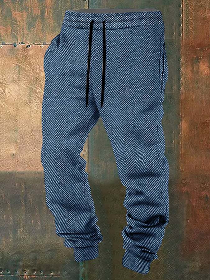 Blue herringbone-patterned pants with drawstring on a textured brown background