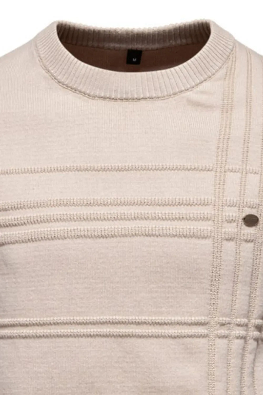 Close-up of a beige knit sweater with a focus on texture and stitching.