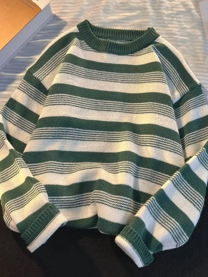 Green and white striped sweater on a flat surface