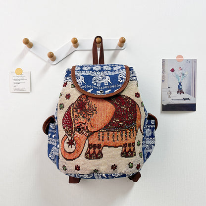 Backpack with elephant design hanging on a wall hook