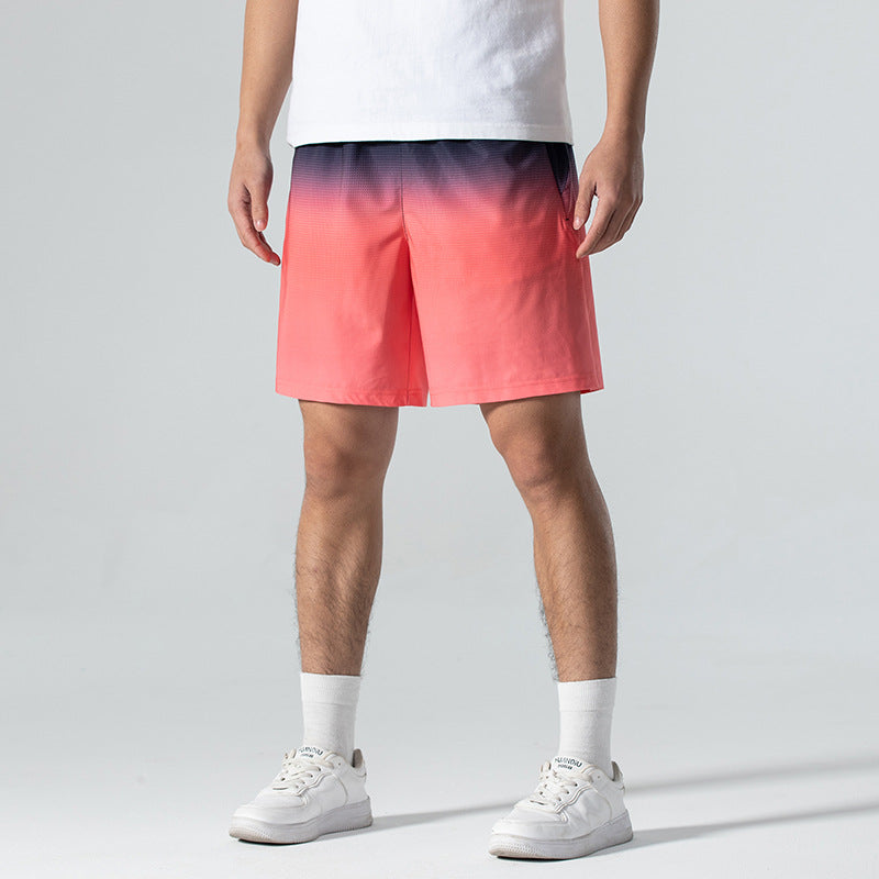 Person wearing a white t-shirt and colorful gradient shorts on a gray background