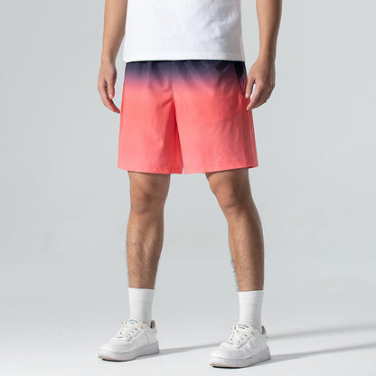Person wearing a white t-shirt and colorful gradient shorts on a gray background