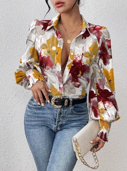 Woman wearing a colorful floral blouse and blue jeans against a white background