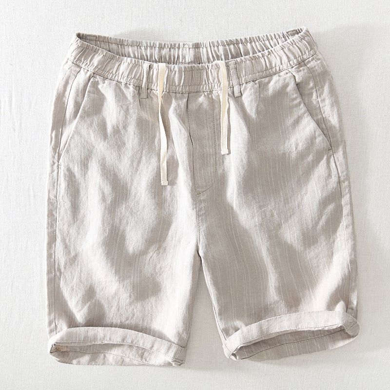Light beige shorts with an elastic waistband on a white background
