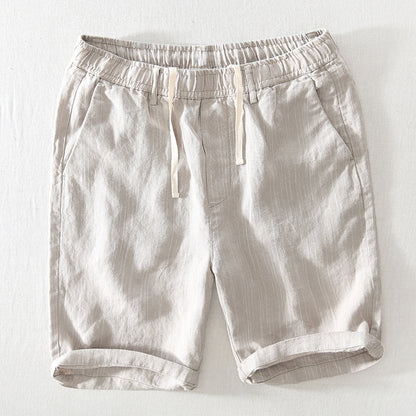 Light beige shorts with an elastic waistband on a white background