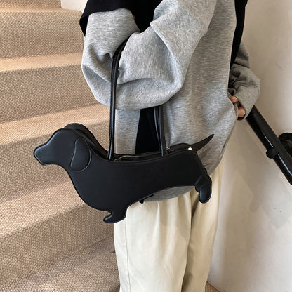Person holding a black dachshund-shaped handlebar grip on a staircase.