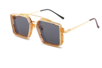 Gold-framed sunglasses with dark lenses on a white background