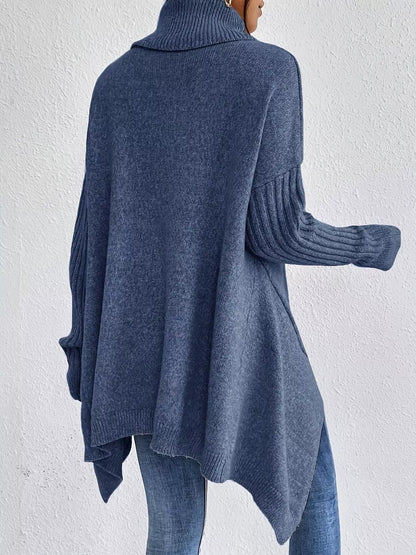 Blue sweater worn by a person against a white background