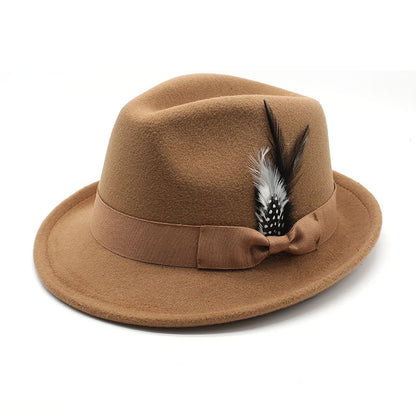 Brown fedora hat with a feather and bow on a white background