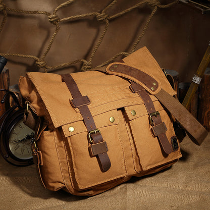 Brown leather satchel bag with straps on a textured surface