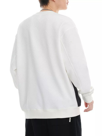 Person wearing a white sweater with a black garment underneath on a white background