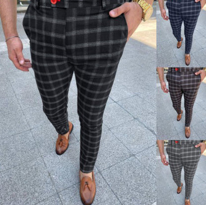 Person wearing black plaid pants with a close-up inset on a pavement background