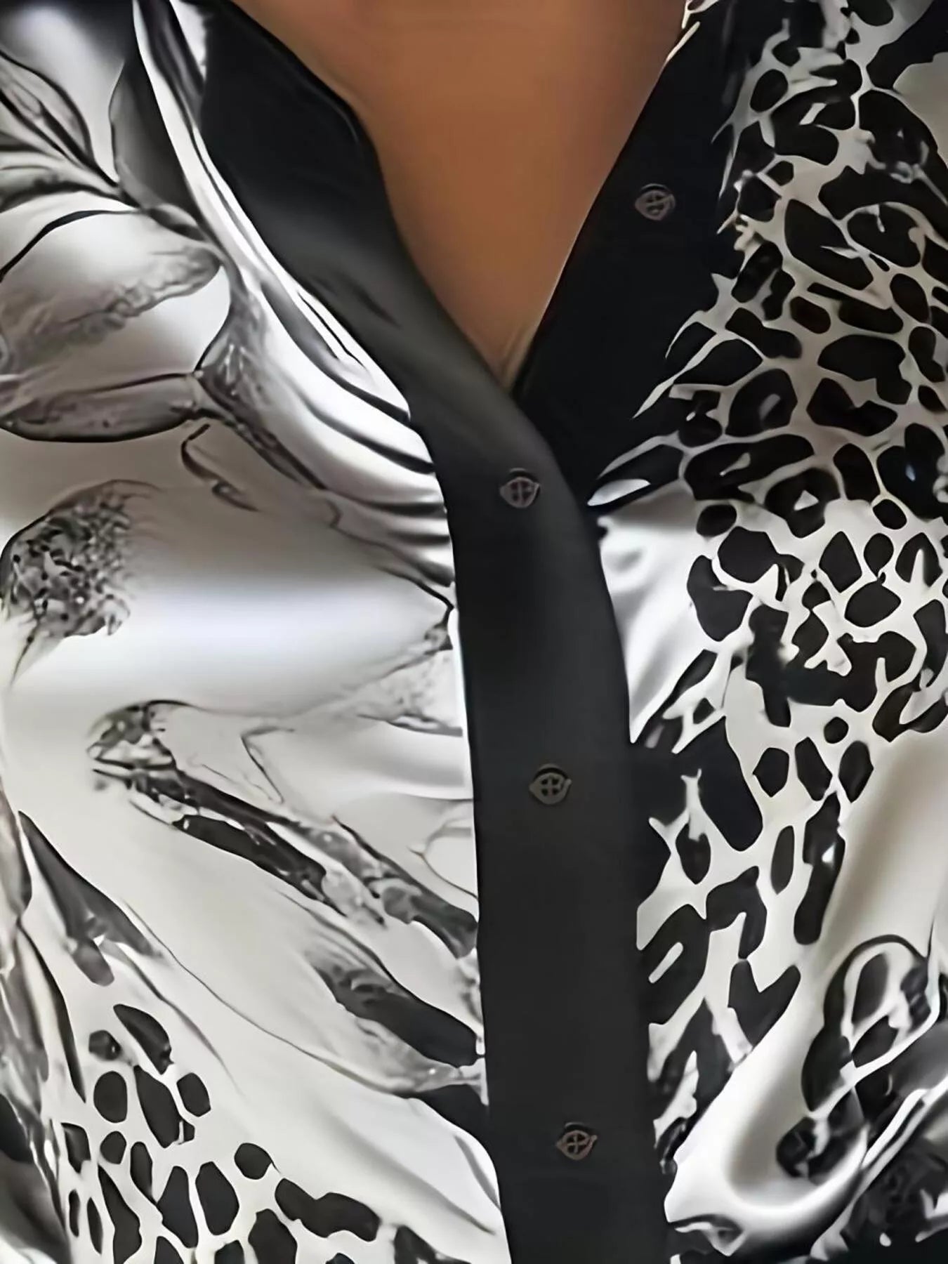 Close-up of a shirt with black and white abstract pattern