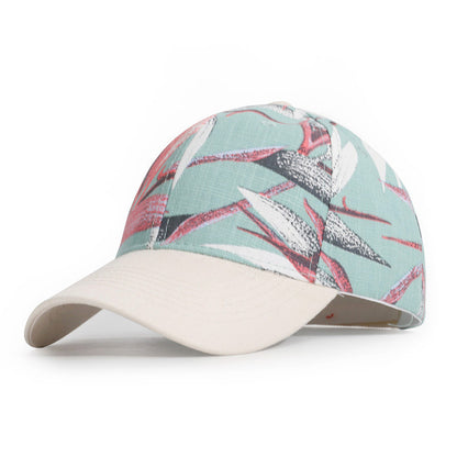 Baseball cap with tropical leaf pattern on a white background