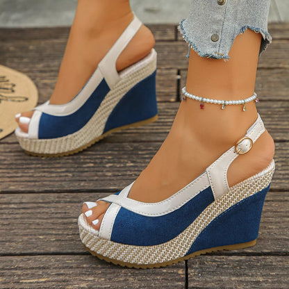 Blue and white wedge sandals on a wooden floor
