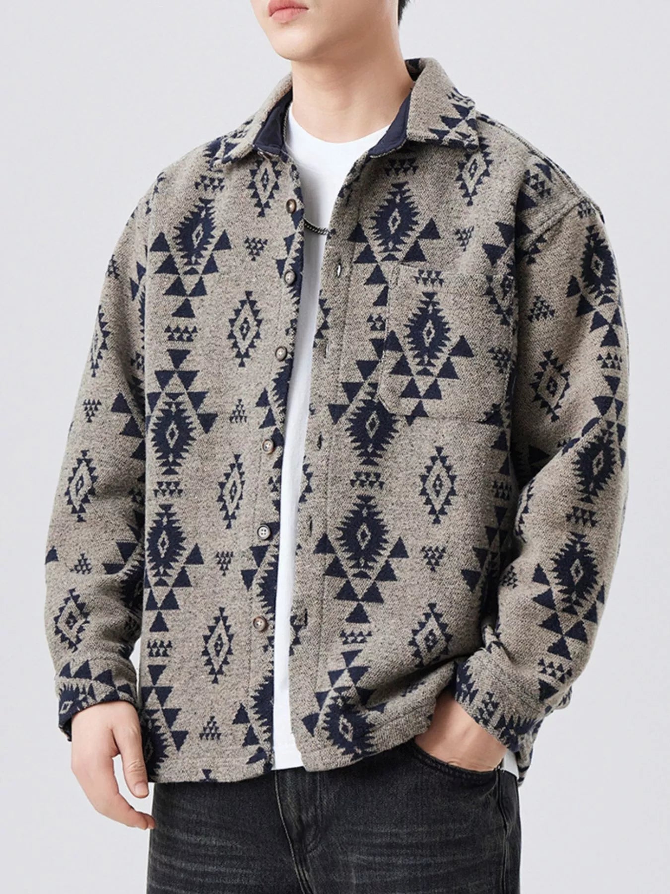 Person wearing a patterned jacket with a plain background