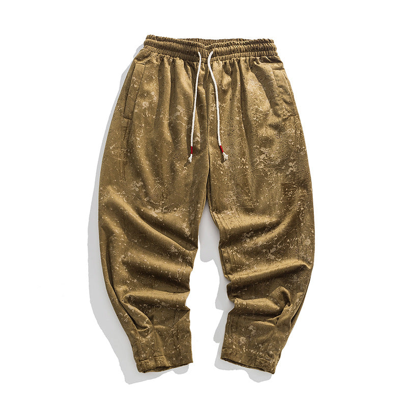Gold velvet jogger pants on a white background