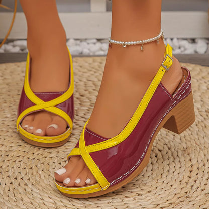 Yellow and Red sandal being worn on a patterned surface