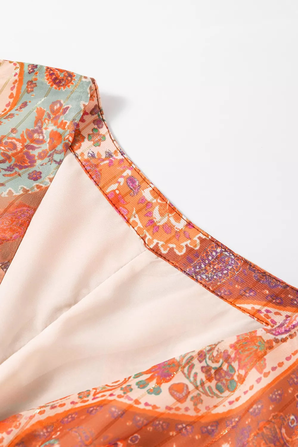 Close-up of a colorful dress with intricate patterns on a white background