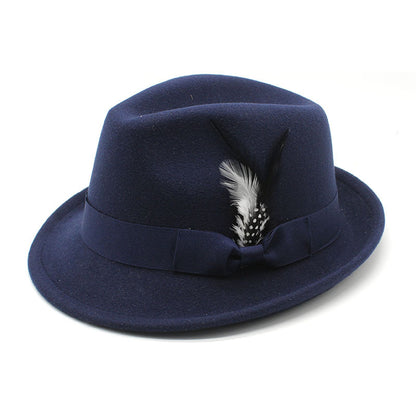 Navy blue fedora hat with a feather on a white background