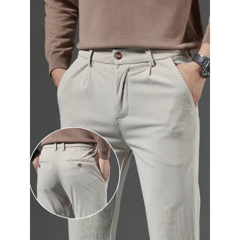Light gray pleated pants with a close-up of the waistband on a dark background
