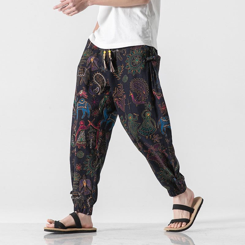 Colorful patterned harem pants worn by a person on a white background