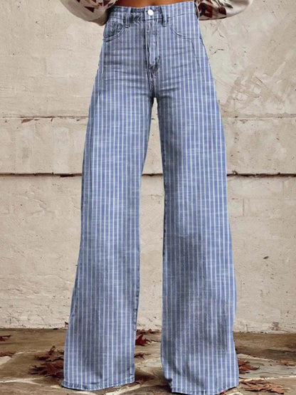 Blue plaid pants worn by a person against a textured wall.