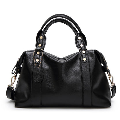 Black handbag with gold accents on a white background