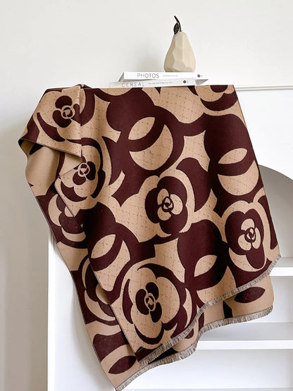Patterned blanket draped over a chair with a white background