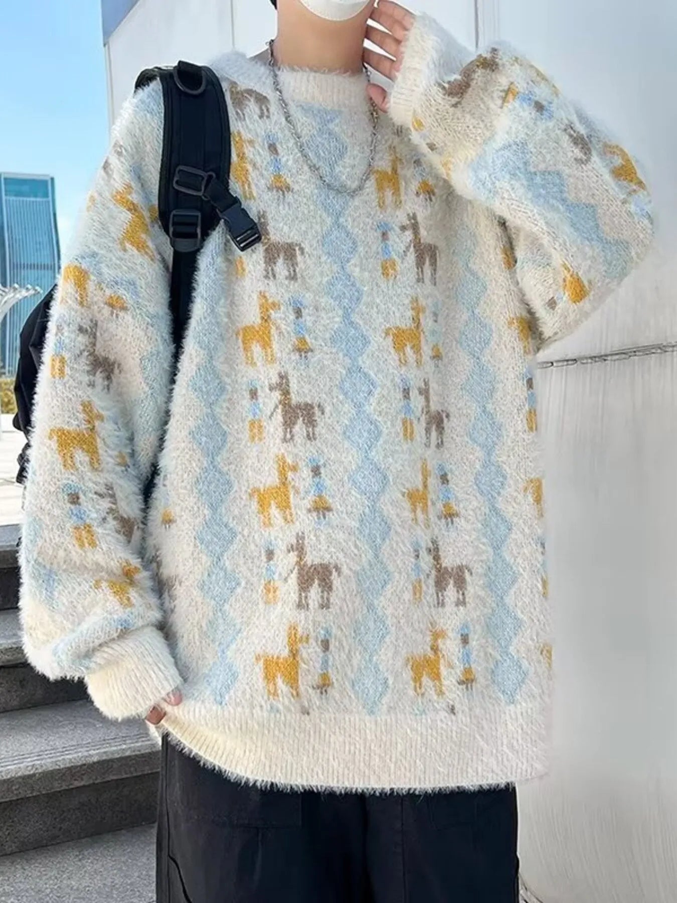 Person wearing a patterned sweater with animals, standing outdoors.