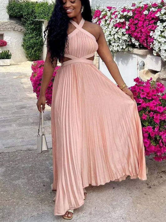 Woman in a pink dress standing in front of flowers
