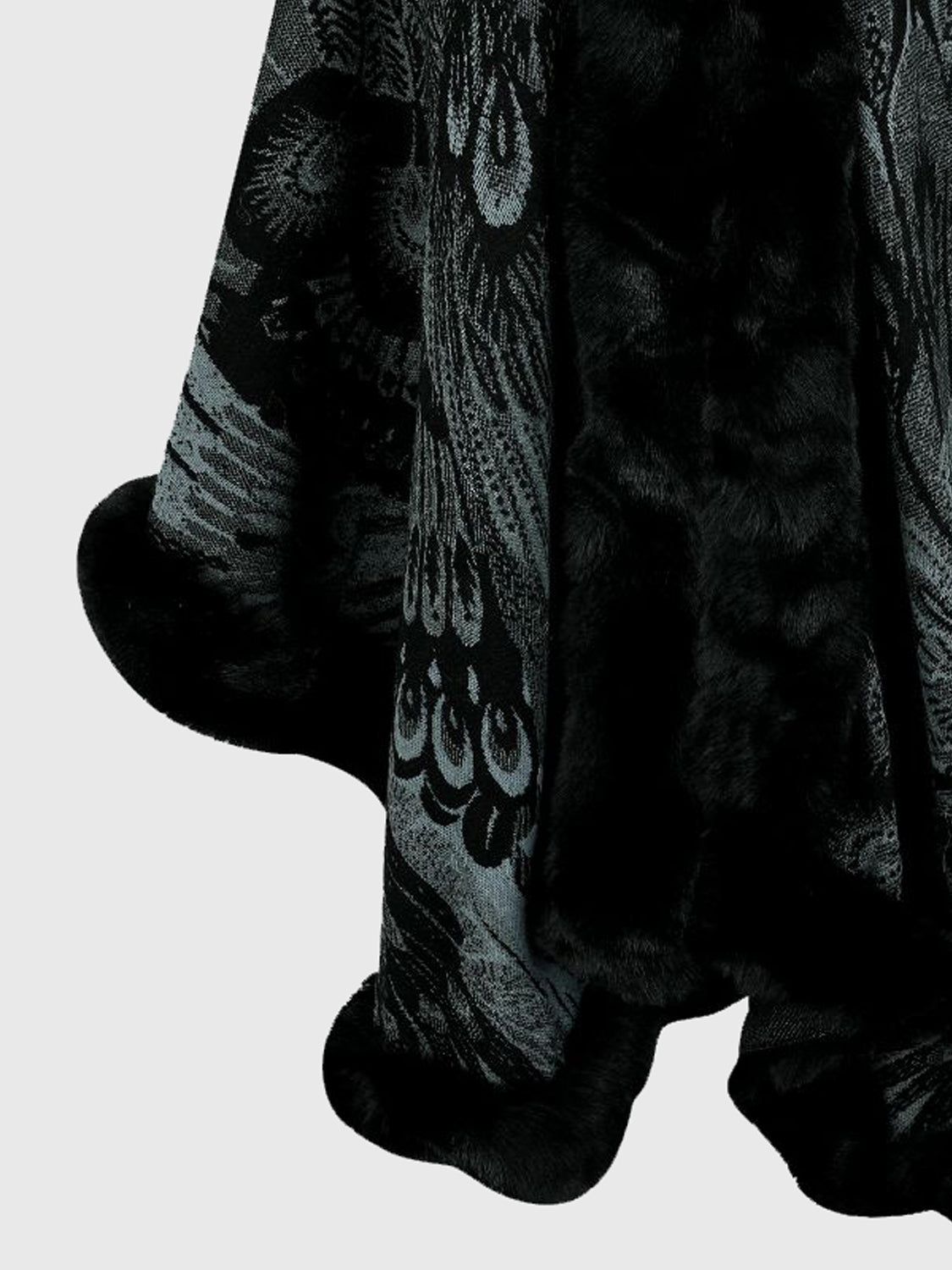 Close-up of a plush toy with intricate patterns on a light gray background