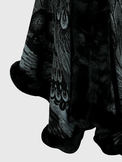 Close-up of a plush toy with intricate patterns on a light gray background