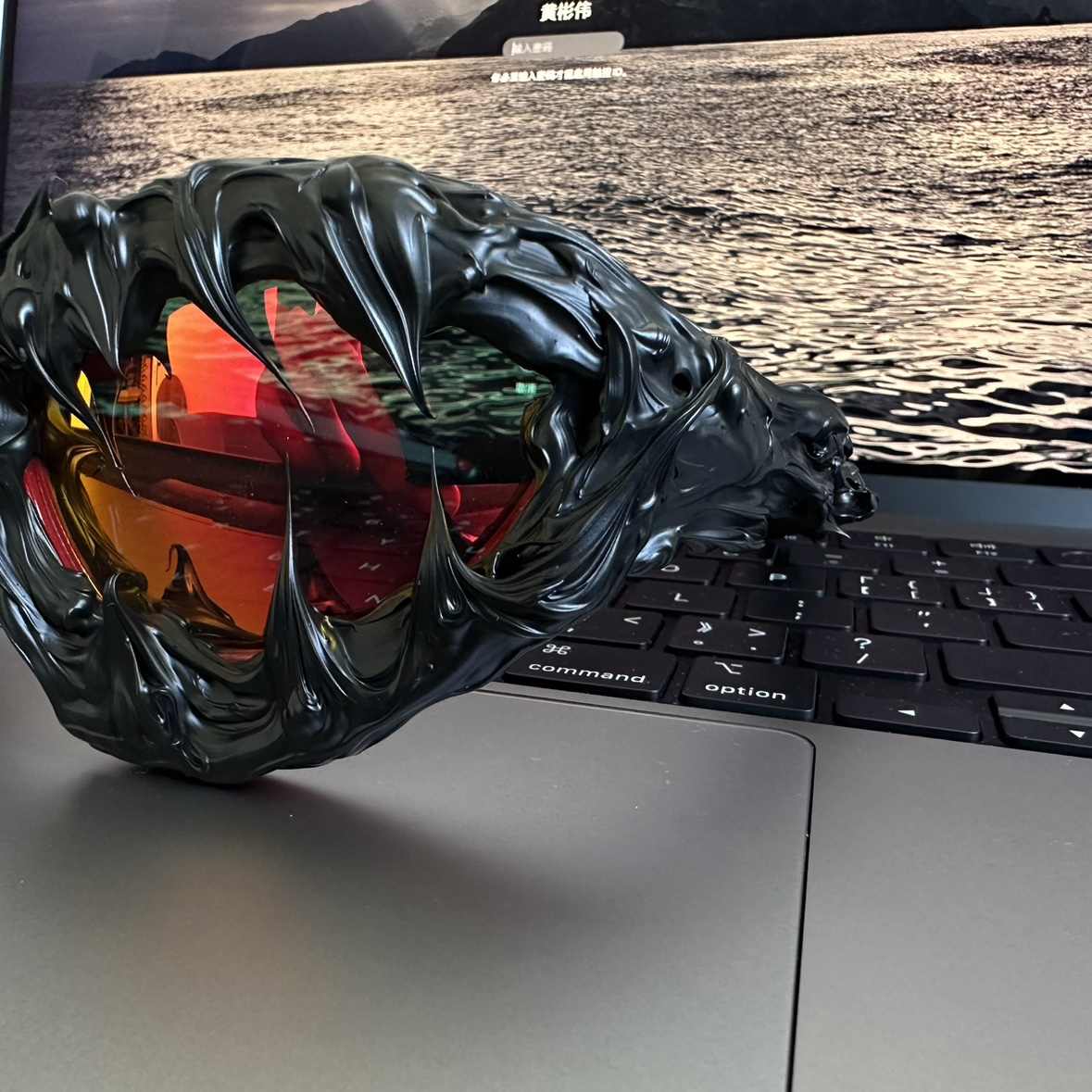 Gloves with dragon design on a laptop keyboard