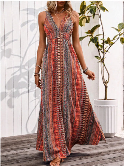 Woman wearing a patterned dress standing on a wooden deck with a plant in the background