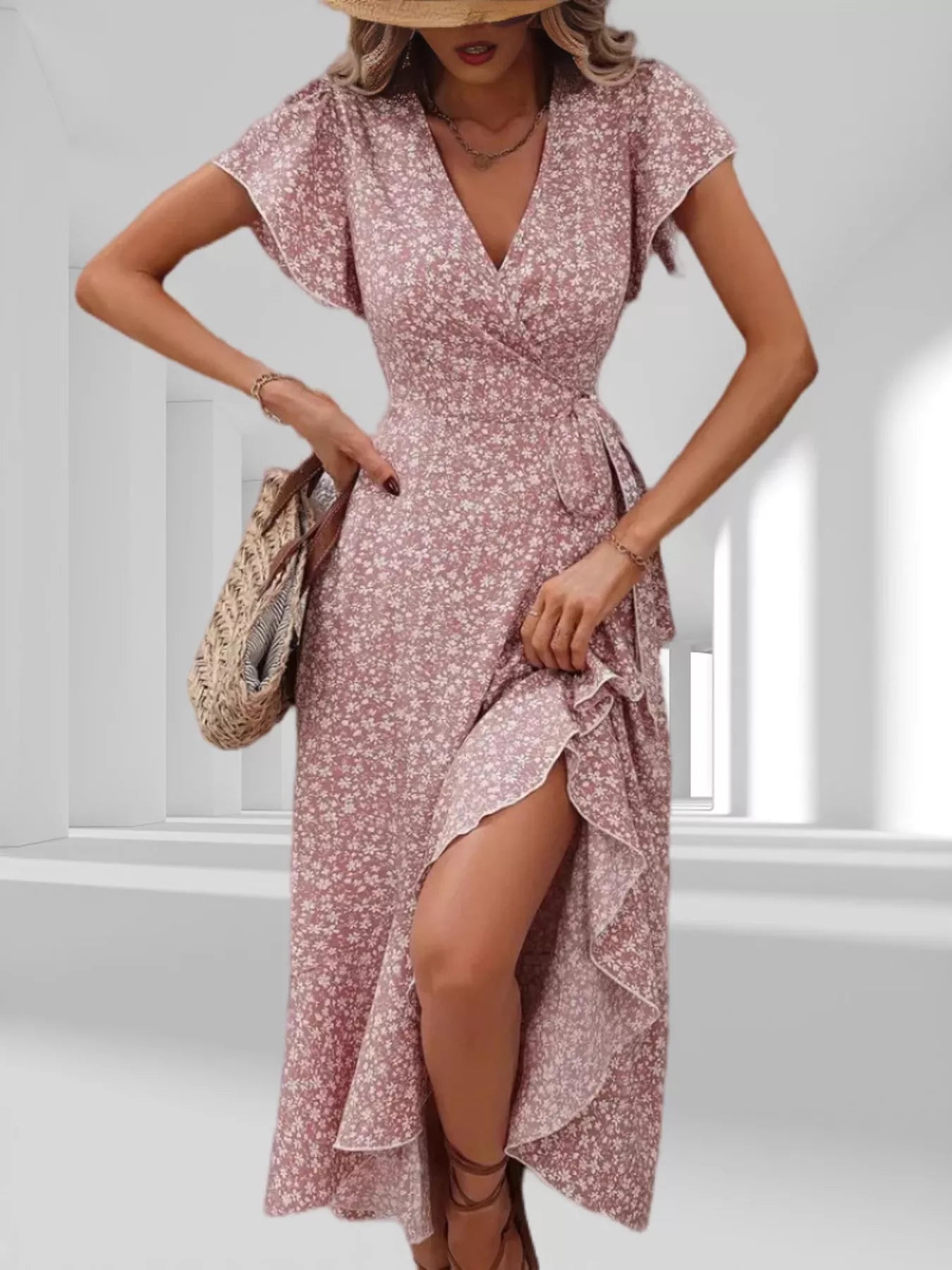 Woman wearing a pink floral dress with a white background